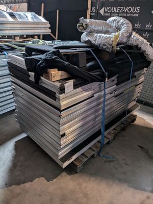 a pile of metal sheets on a pallet in a warehouse