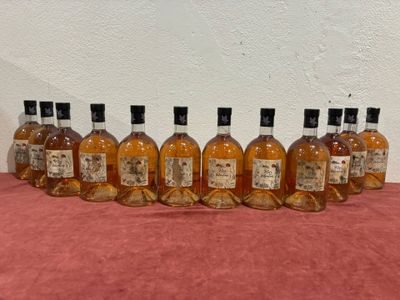six bottles of whisky lined up in a row on a table
