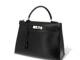 a black leather handbag on a white background