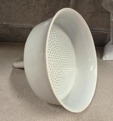 a close up of a white coffee cup on a counter