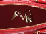 a red purse with a bunch of keys inside of it
