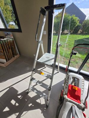 a ladder that is next to a window in a room