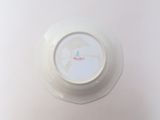a white bowl with a red and blue design on it