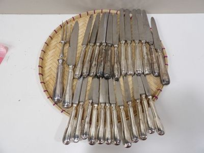 a lot of knives on a plate on a table