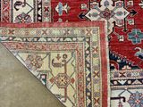 an image of a red and blue rug on a brown floor