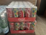 several cans of coca cola are stacked on top of each other