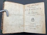 an open book with a handle on top of it on a table