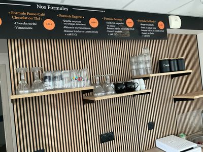 a menu board on the wall of a coffee shop