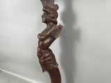 une vieille étagère en bois sur laquelle est sculptée une figurine