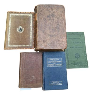 several old books sitting on top of each other on a white surface