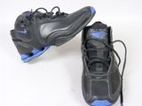 pair of black and blue sneakers on a white surface