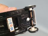 a person holding a small toy car in their hand