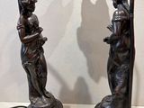 pair of antique bronze table lamps with a woman holding a flower