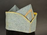a gray hat with a yellow zipper on it