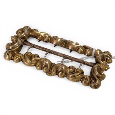 an image of a gold colored metal buckle with a decorative design