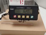 an electronic scale on a box on a table