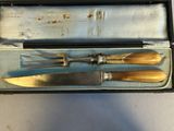 three knives in a box that are sitting on a table