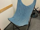 a blue chair that is in a room with wood floors