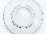 a white plate with a blue stripe on it