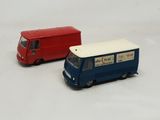 two toy trucks that are sitting next to each other