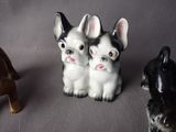 three figurines of dogs sitting next to each other