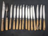 a group of knives and knives with wooden handles on a table