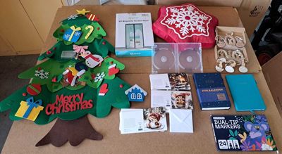a table that has a christmas tree, books, and other items on it