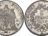a silver coin with an image of a woman and a man on it