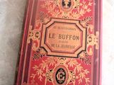 un livre rouge posé sur une nappe en dentelle