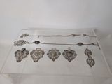 a glass table with a lot of silver items on it
