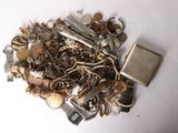 a pile of assorted metal items on a white surface