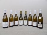 six bottles of wine are lined up on a table