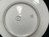 a white plate with a green and white design on it
