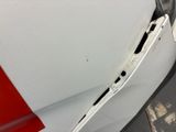 a close up of the front bumper of a car with a dent in it