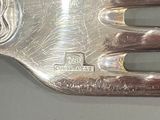 a silver plate with a fork on it on a table