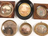 many framed pictures of men and women on the wall