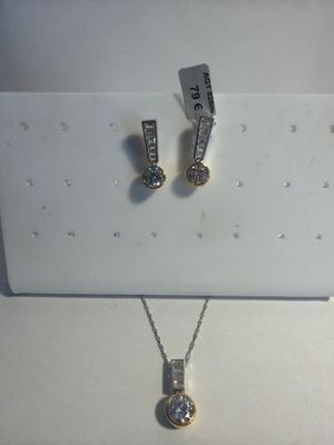 a necklace and earring set on display in a box