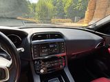 the interior of a car with red leather seats and a steering wheel