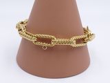 a close up of a gold chain bracelet on a mannequin