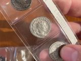 a person holding a box of coins on a table