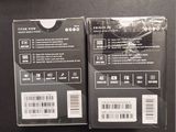 packaging of a pair of black and white electronic devices sitting on a table