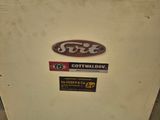 a white refrigerator with stickers on it in a room