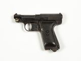 a black gun on a white surface with a white background