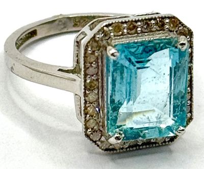 une image d'une bague avec une topaze bleue entourée de diamants