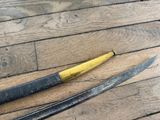 two knives that are laying on a wooden floor