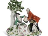 une image représentant une figurine d'un homme et d'une femme accompagnés d'un chien