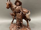 a statue of a man riding a horse with a hat on