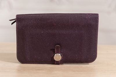 a purple purse sitting on top of a wooden table