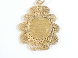 an image of a gold pendant with a coin in the center