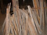a pile of wood that is sitting in the dirt